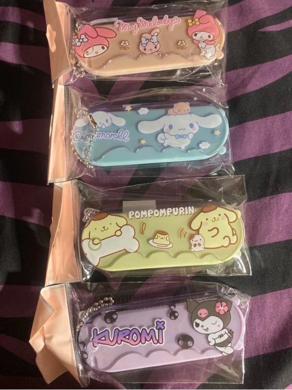 Sanrio pastel character key pouches — pink, blue, green, purple